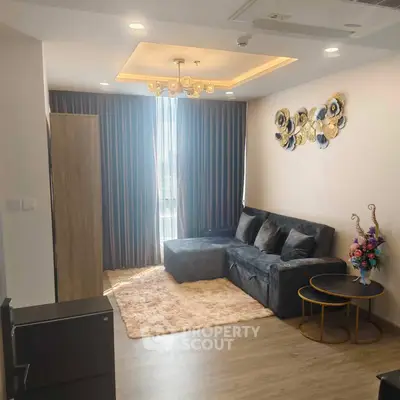 Modern living room with stylish decor and cozy seating area, perfect for relaxation.
