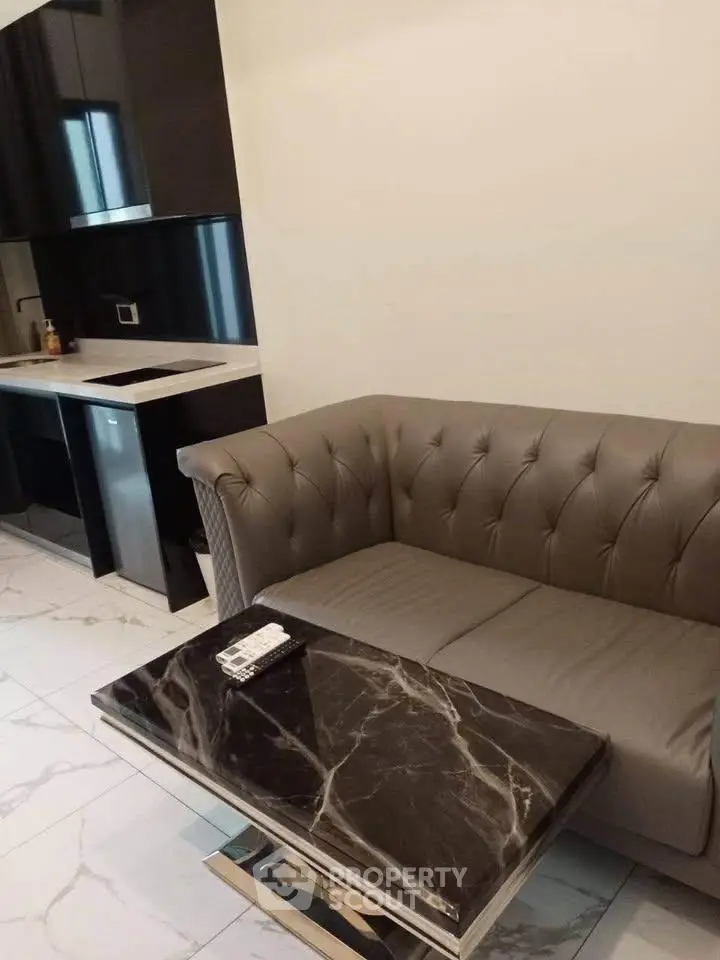 Modern living room with elegant sofa and marble coffee table in a stylish apartment.