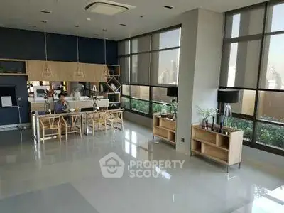 Spacious modern living room with large windows and stylish furniture