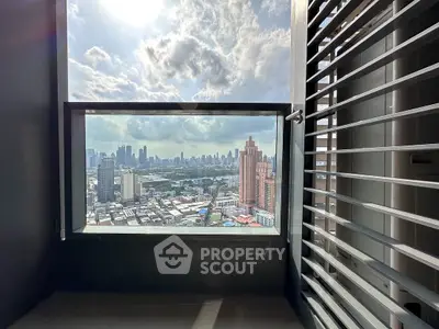 Stunning cityscape view from a high-rise balcony with modern railing.