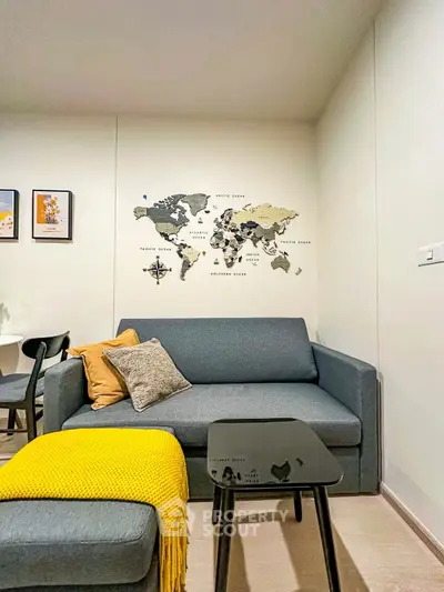 Modern living room with stylish gray sofa and world map wall art