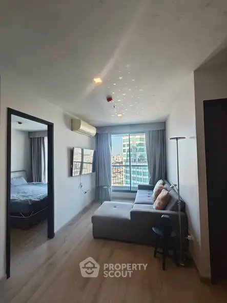 Modern living room with cozy sofa and city view from window