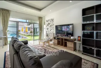 Luxurious living room with pool view and modern entertainment setup