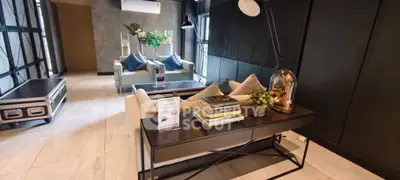 Modern living room with stylish decor, featuring a cozy sofa, elegant lighting, and contemporary furnishings.