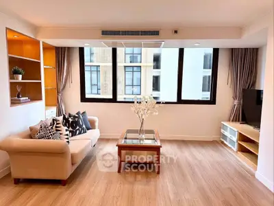 Spacious modern living room with large windows and elegant decor