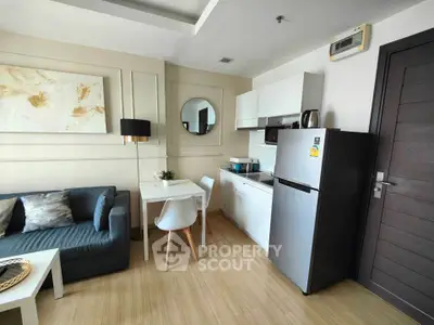 Modern studio apartment with stylish decor and compact kitchen