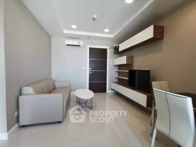 Modern living room with sleek furniture and wall-mounted TV in a stylish apartment.