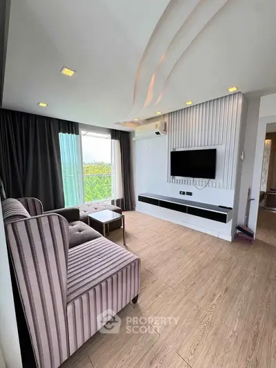 Modern living room with stylish furniture and wall-mounted TV, featuring large windows and elegant decor.