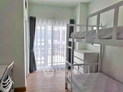 Bright bedroom with bunk beds and balcony access in modern apartment