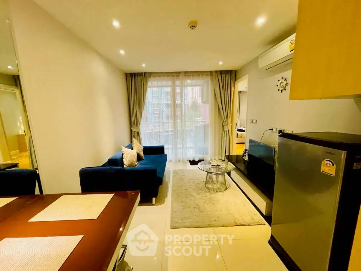 Modern living room with cozy blue sofa and stylish decor in a bright apartment.