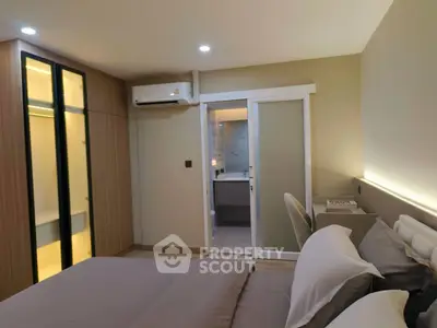 Modern bedroom with ensuite bathroom and sleek wardrobe design