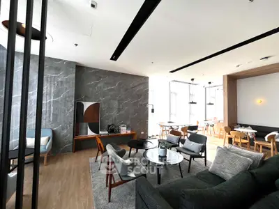 Modern living room with stylish furniture and large windows in a contemporary apartment.