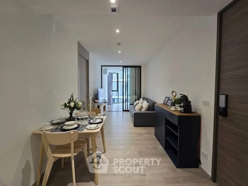 Modern living room with dining area and stylish decor in a contemporary apartment.