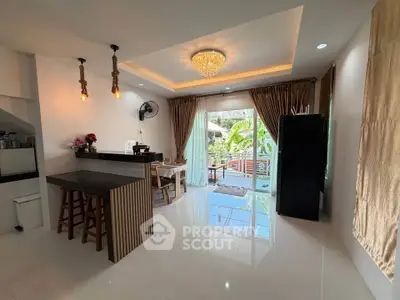 Spacious open-layout kitchen and dining area with modern lighting and garden view.