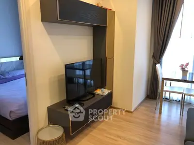 Modern living room with sleek TV unit and dining area, perfect for cozy urban living.