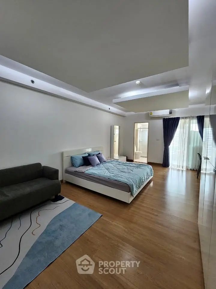 Spacious modern bedroom with elegant decor and natural light