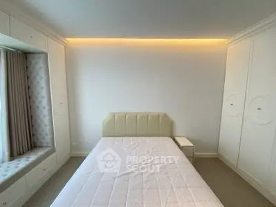 Elegant bedroom with built-in storage and cozy window seat