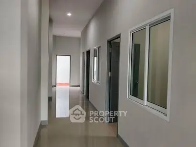 Spacious modern hallway with sleek design and polished floors in a contemporary building.