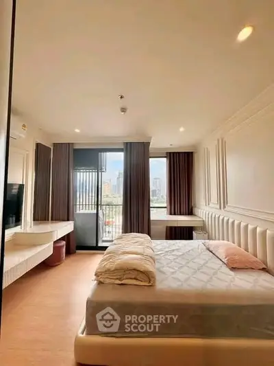 Spacious bedroom with city view and modern decor in luxury apartment