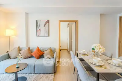 Modern living room with cozy sofa and elegant dining area in a stylish apartment.