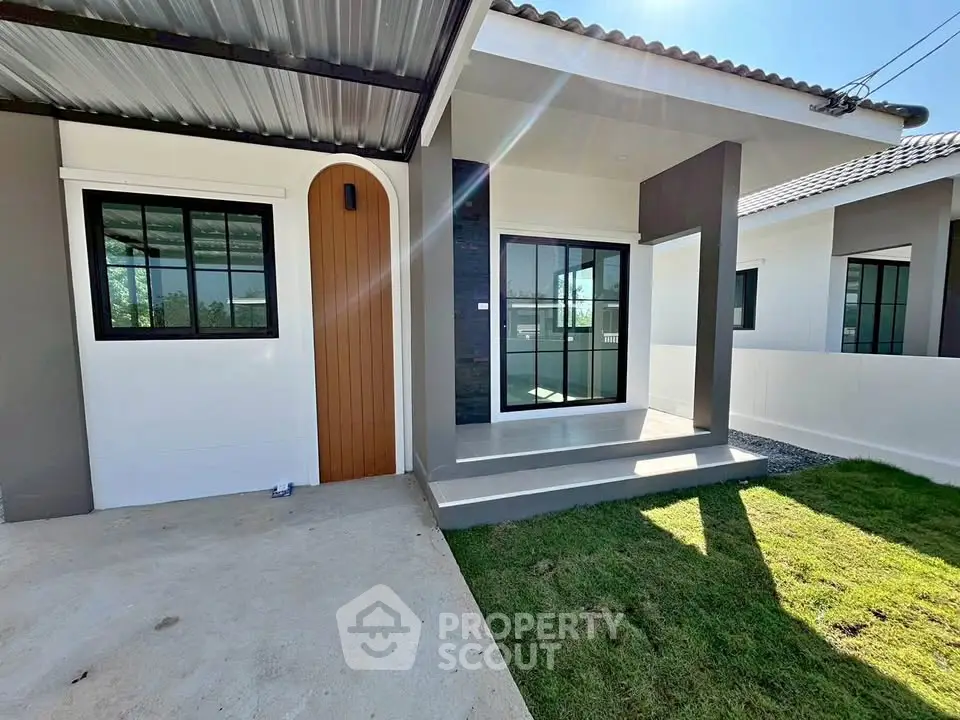 Modern single-story house with sleek design and spacious front yard