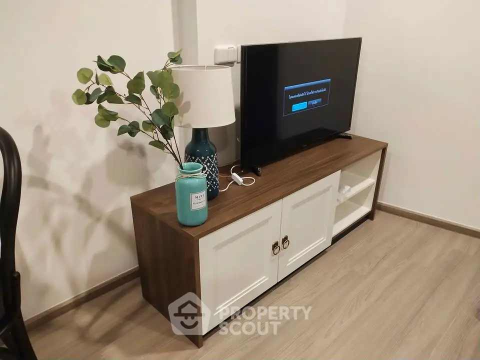 Modern living room corner with stylish TV stand and decor