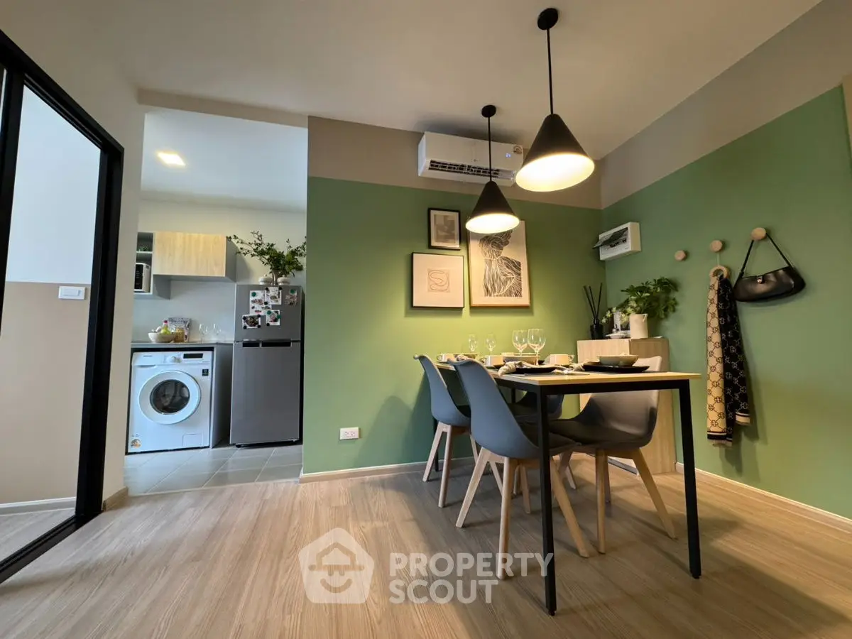 Modern dining area with stylish decor and adjacent laundry space