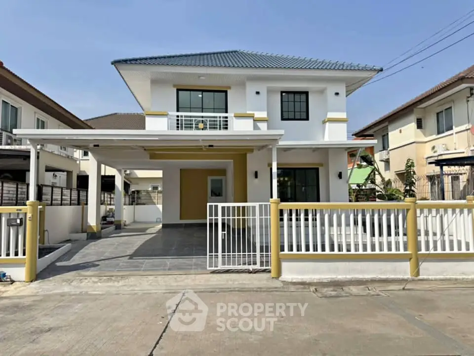 Modern two-story house with spacious driveway and gated entrance in a suburban neighborhood.