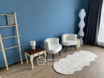 Stylish modern living room with elegant white chairs and unique decor