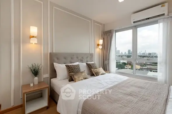 Luxurious bedroom with city view, elegant decor, and natural light.