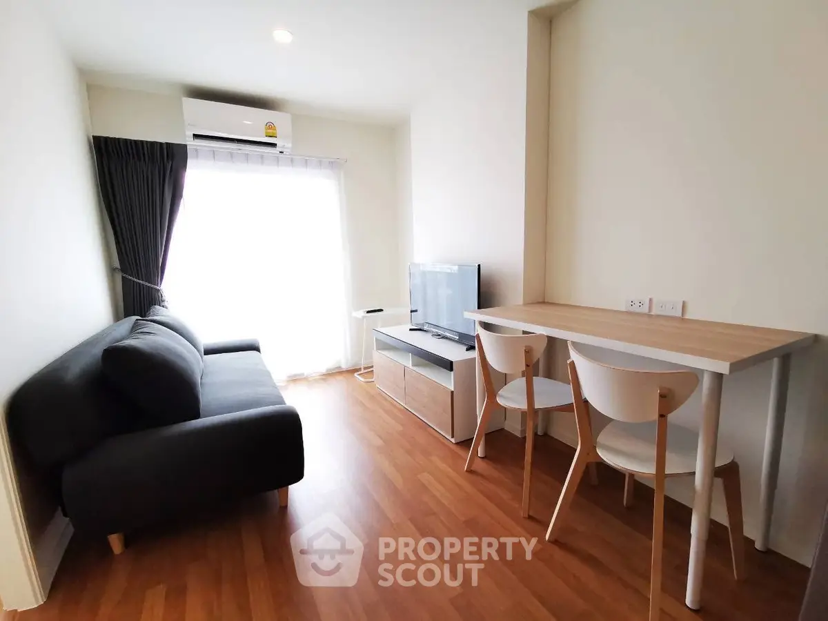Modern living room with sleek furniture and natural light in a stylish apartment.