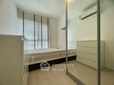 Modern minimalist bedroom with mirrored wardrobe and air conditioning