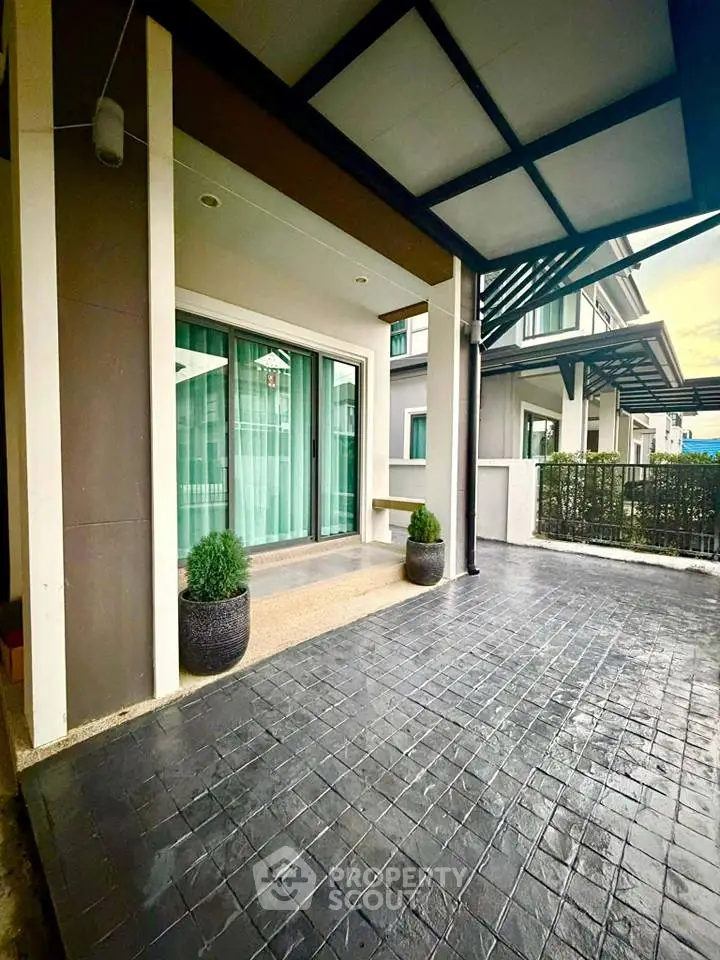 Modern home entrance with spacious patio and stylish design.