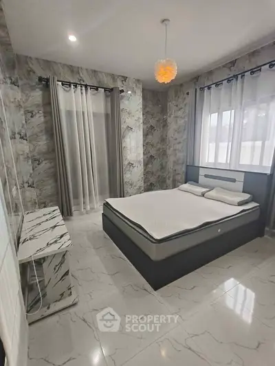 Luxurious bedroom with modern decor and large windows for natural light