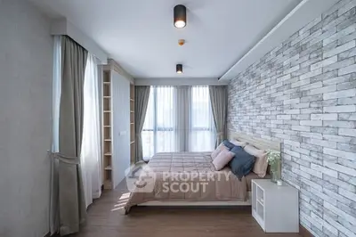 Modern bedroom with stylish brick accent wall and large windows