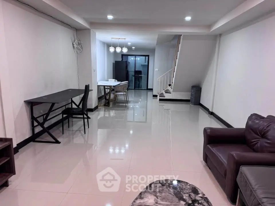Spacious modern living room with sleek furniture and open layout, perfect for entertaining.