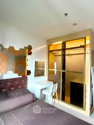 Modern bedroom with stylish decor and walk-in closet, featuring a cozy bed and elegant wall design.