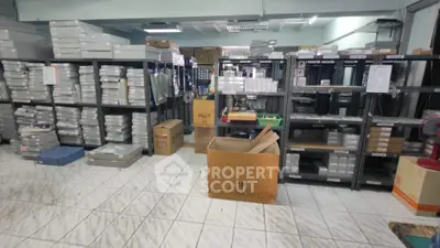 Spacious storage room with organized shelves and boxes, ideal for inventory management.