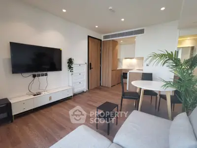 Modern living room with sleek furniture and open kitchen layout