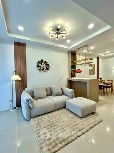 Modern living room with cozy sofa and elegant lighting in open layout