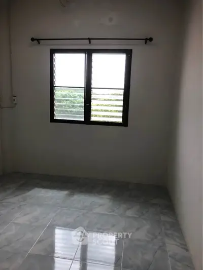 Minimalist empty room with tiled floor and window, perfect for customization.