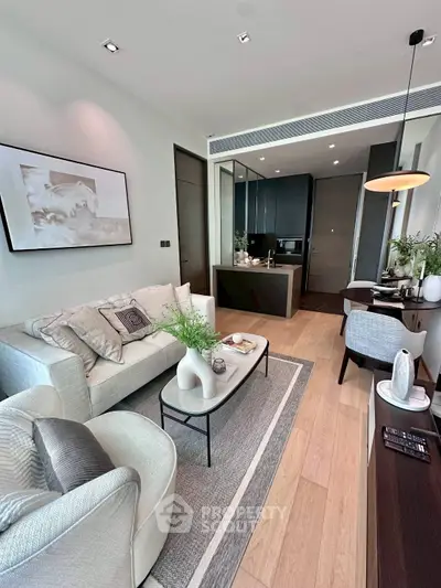 Modern living room with elegant decor and open kitchen layout in a stylish apartment.
