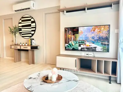 Modern living room with stylish decor and wall-mounted TV