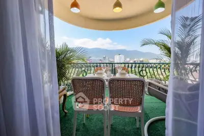 Charming balcony with stunning city and mountain views, perfect for relaxing and enjoying outdoor dining.