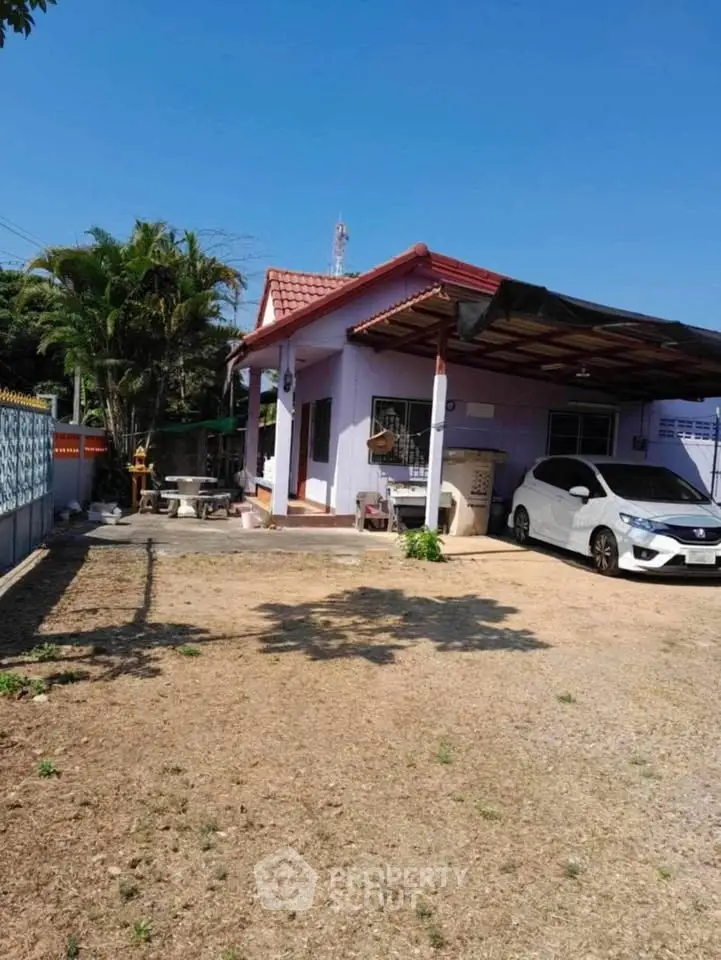 Charming single-story home with carport and spacious yard, perfect for family living.