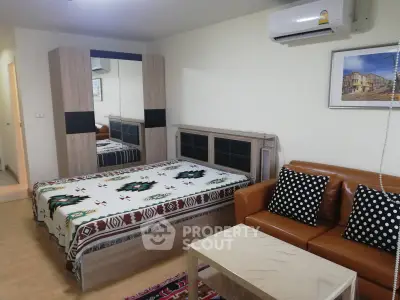Cozy studio apartment with modern furniture and air conditioning, perfect for urban living.