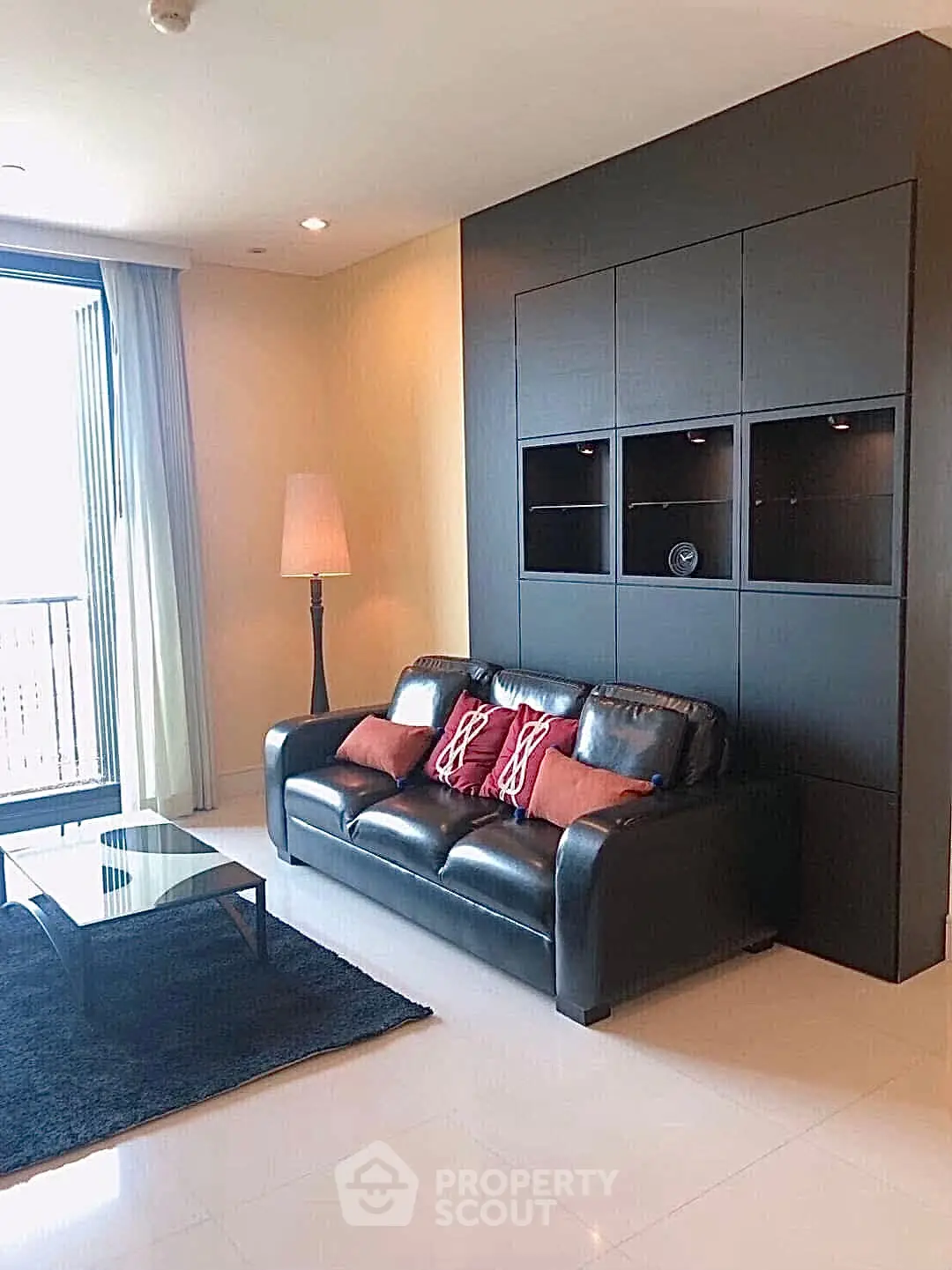 Modern living room with sleek black sofa and stylish decor