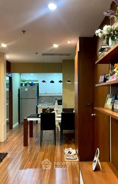 Modern open-layout kitchen with dining area and wooden flooring