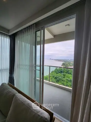 Stunning ocean view from modern balcony with sliding glass doors