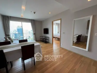 Spacious modern living room with wooden flooring and city view balcony